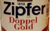 Фирменная бутылка и бокал австрийского пива Zipfer Doppel Gold